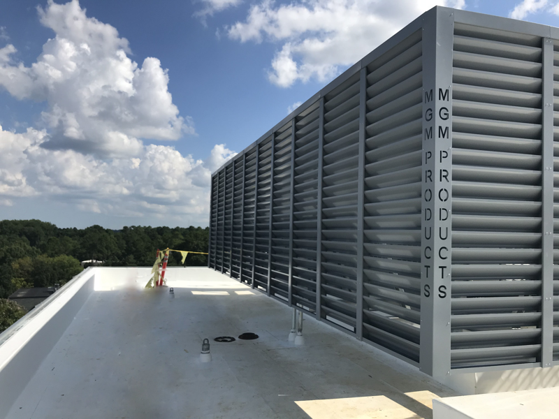 large white louvered equipment screen enclosure on rooftop, architectural metal screening, hiding HVAC units, cloudy sky, Canti-Louver system